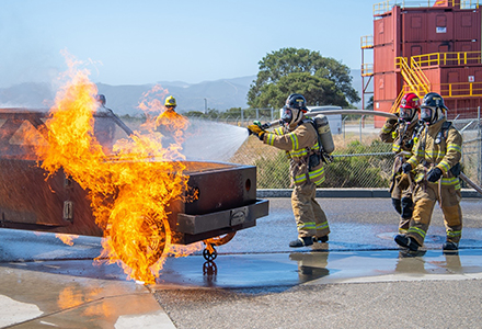 Cadets demonstrate their fire academy skills at their graduation ceremony.
